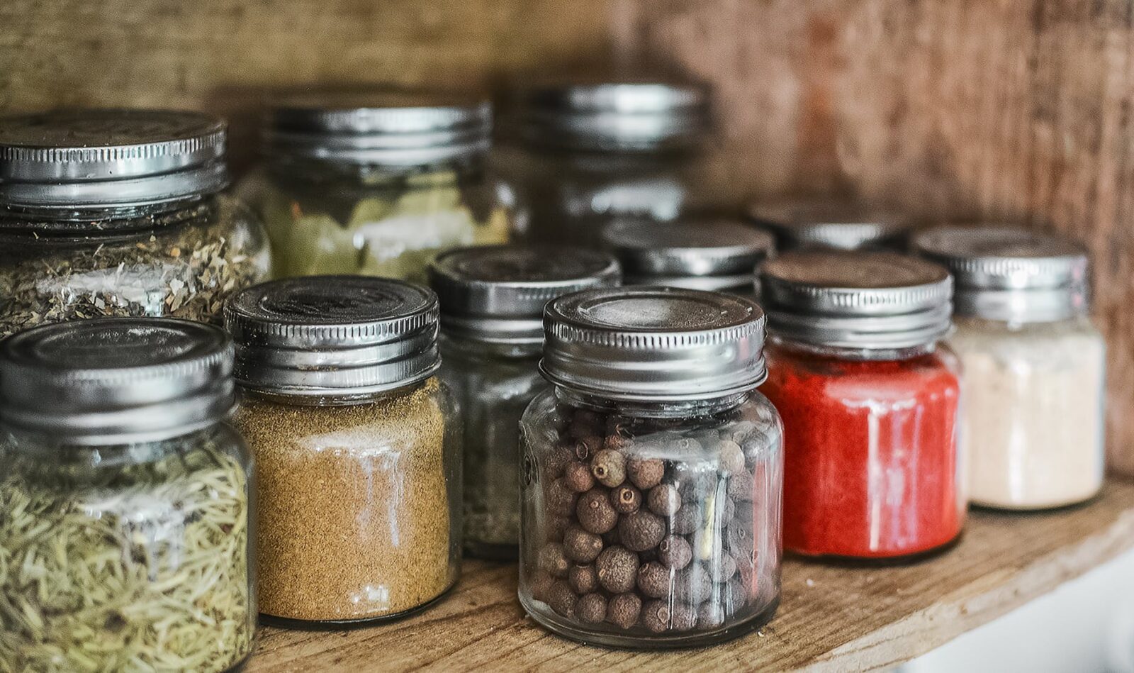90 Unique Spices to Grow in Your Herb Garden 6 Glass mason jars of dried herbs and spices