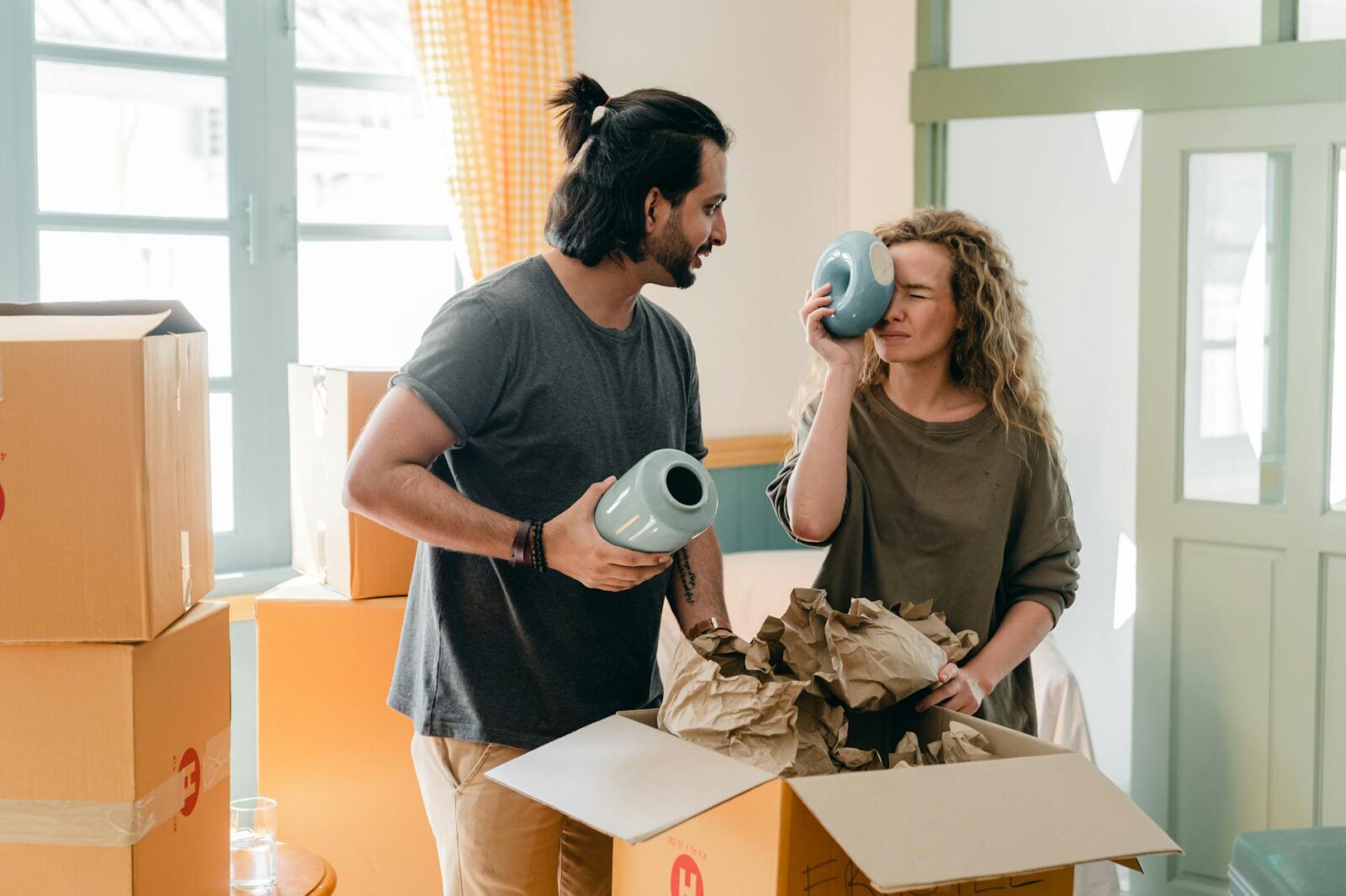 Moving House? Here’s Your Ultimate Moving Checklist 10 multi ethnic couple with ceramic vases and pile of cardboard boxes Moving House? Here’s How to Make Things Less Stressful