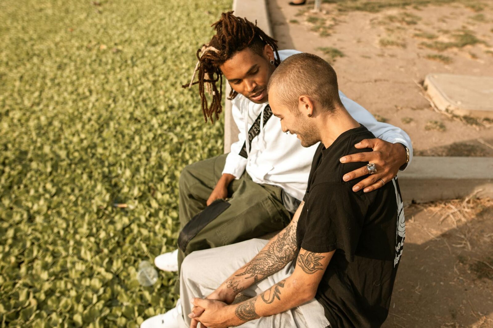 friends sitting in a park How To Develop Resilient Mental Health
