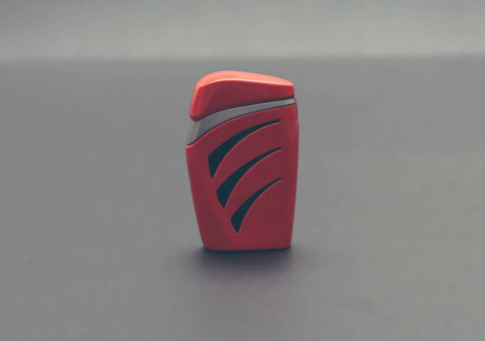 What Goes Into Product Design? 6 Key Steps to Create a Successful Product 10 Close-up of a red container with a sleek design, featuring stylized black markings, set against a neutral background. What Goes Into Product Design? 6 Key Steps to Create a Successful Product