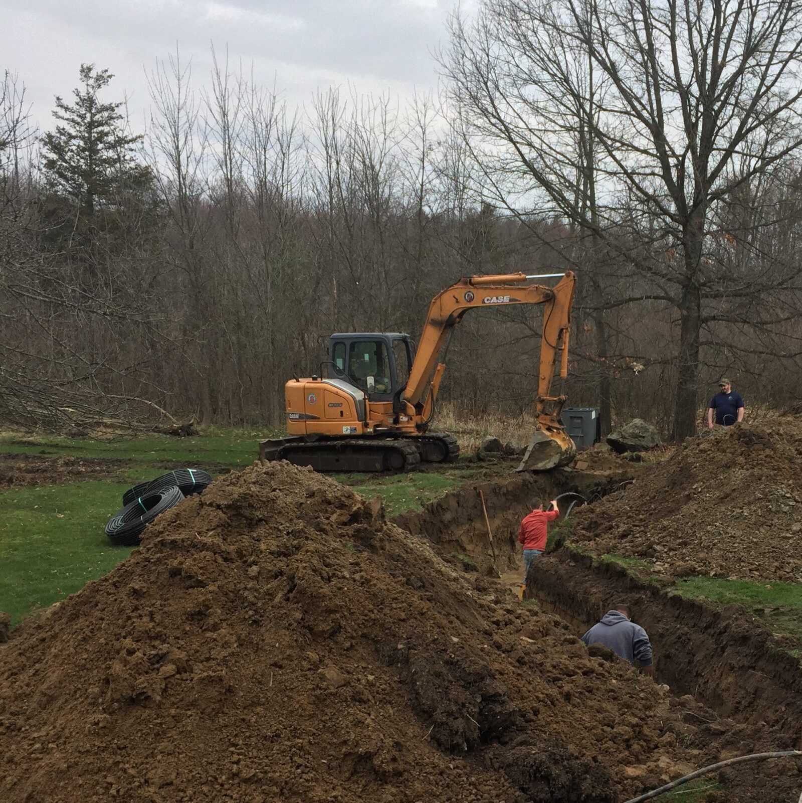 Is Geothermal Right for You? (Taking Your Homestead Off-Grid) 9 Backhoe digging geothermal trench