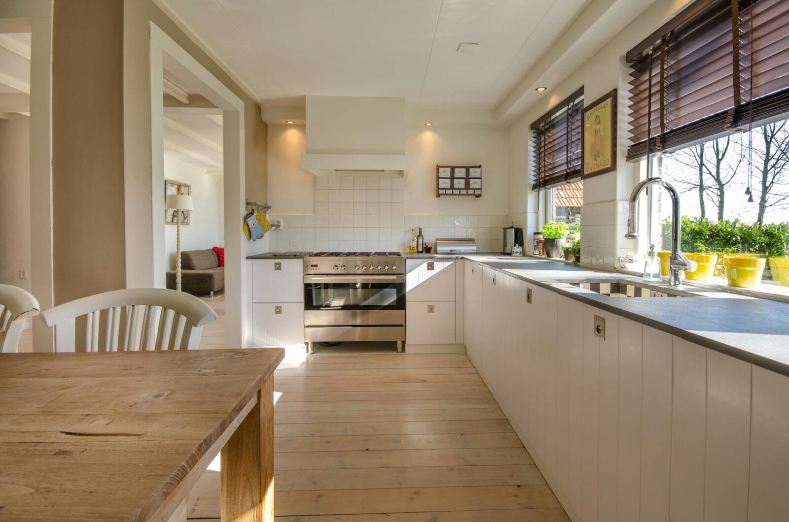 brown wooden table near window 5 Easy Home Design Tips to Refresh Your Space