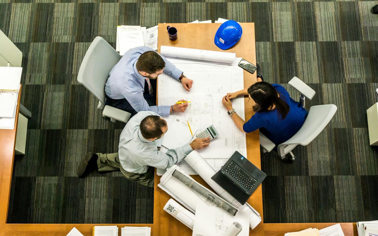 How to Move Offices Successfully: A Step-by-Step Business Relocation Guide 8 three people sitting beside table How to Move Offices Successfully: A Step-by-Step Business Relocation Guide