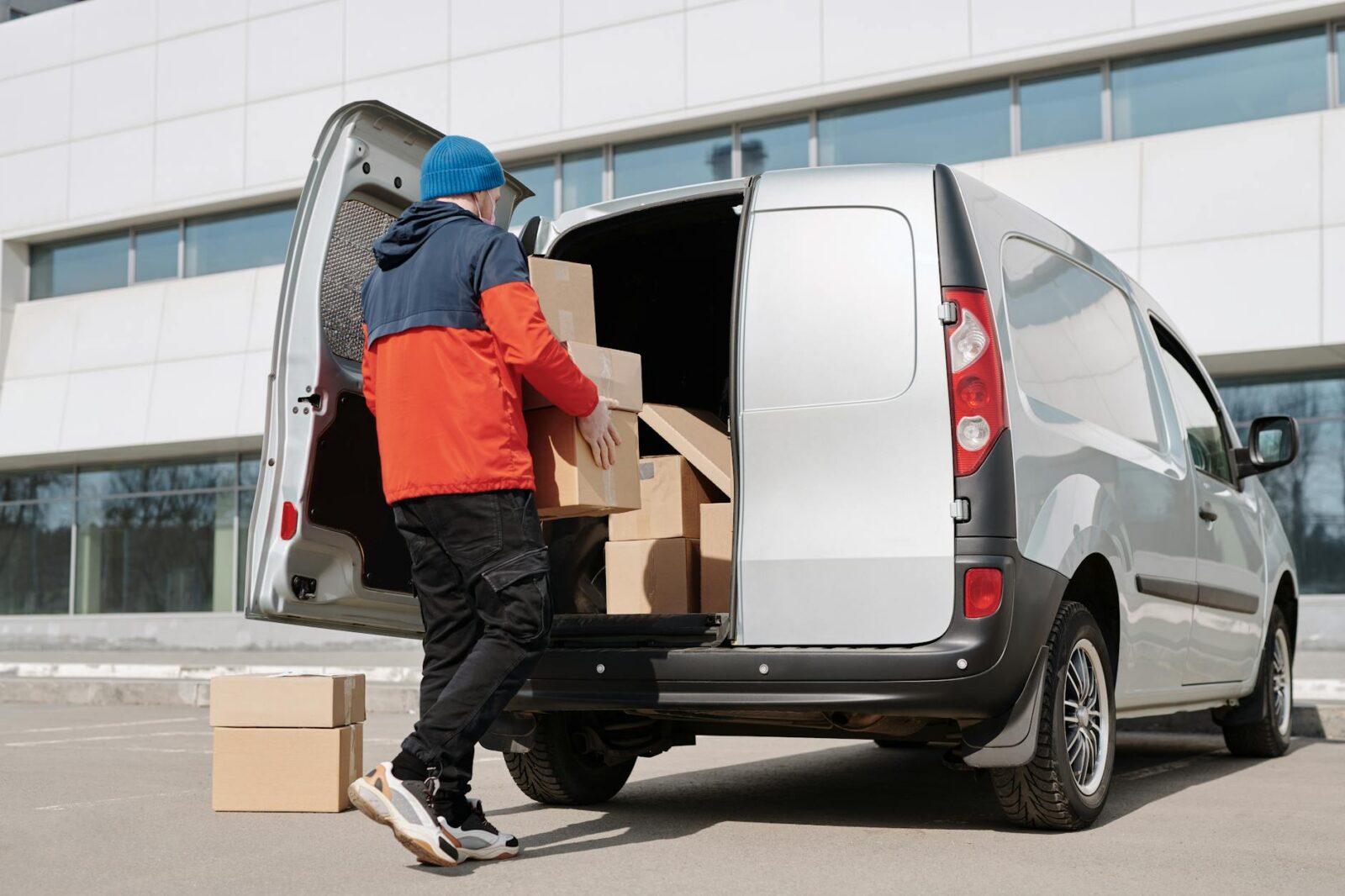 How to Move Offices Successfully: A Step-by-Step Business Relocation Guide 9 a man in a jacket loading boxes in a van How to Move Offices Successfully: A Step-by-Step Business Relocation Guide