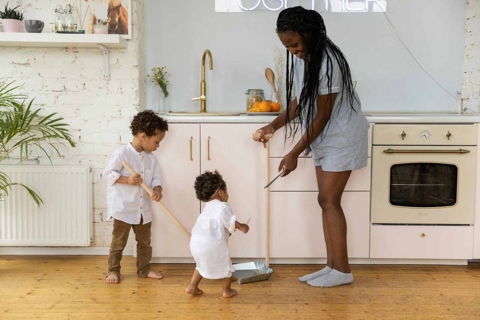 12 Essential Life Skills to Teach Your Kids (Beyond School Lessons) 16 mother and children in kitchen 12 Essential Life Skills to Teach Your Kids (Beyond School Lessons)