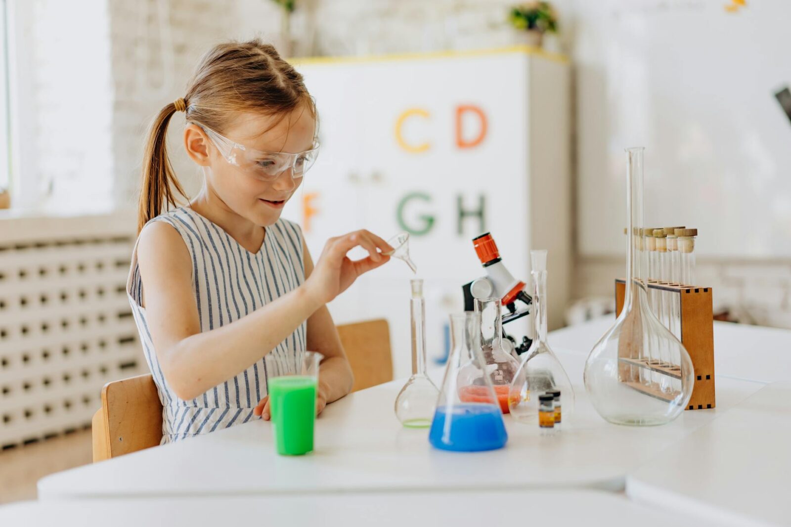 12 Essential Life Skills to Teach Your Kids (Beyond School Lessons) 19 a girl doing a science experiment 12 Essential Life Skills to Teach Your Kids (Beyond School Lessons)