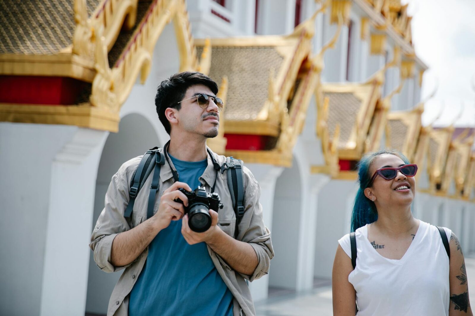 man and woman wearing sunglasses looking up 6 Careers That Let You Travel and Work At The Same Time